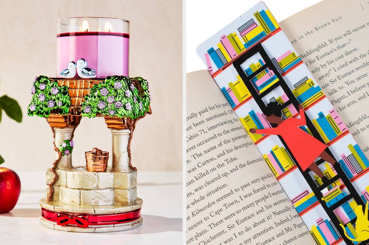 Decorative candle holder featuring birds and vines next to a colorful bookshelf-themed bookmark in an open book