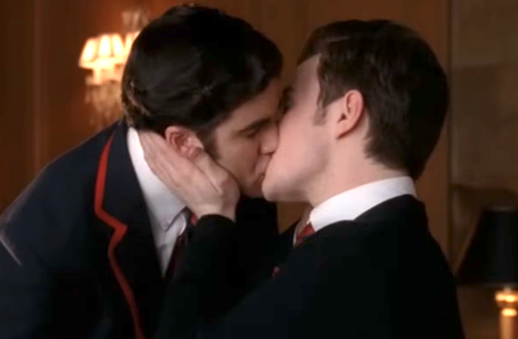 Two characters from a TV amusement   stock  a kiss, some  wearing schoolhouse  blazers