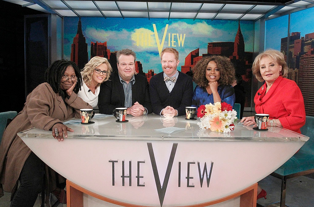 TV amusement   sheet  with six co-hosts sitting astatine  "The View" desk, smiling and posing for the camera