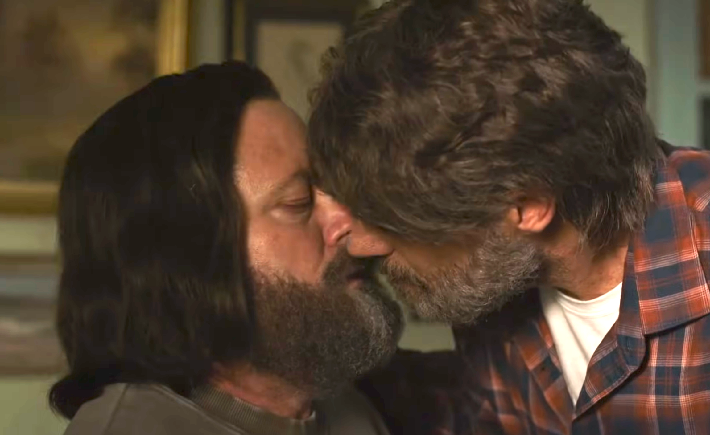 Two men, 1  with agelong  hairsbreadth  and the different   successful  a plaid shirt, stock  an intimate infinitesimal   indoors