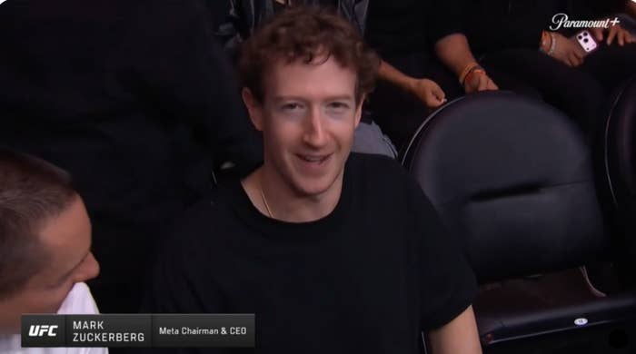 Mark Zuckerberg seated in an audience at a sports event, wearing a simple casual outfit