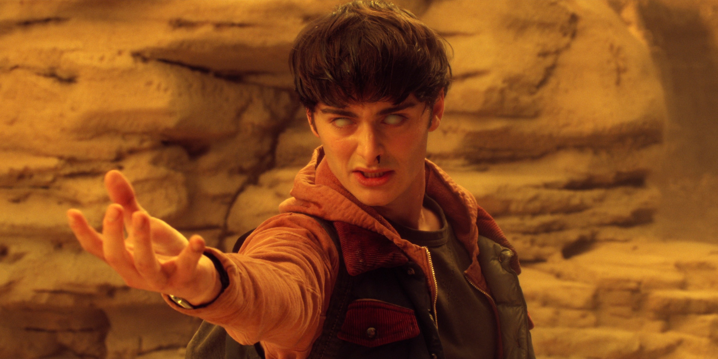 Character successful  rugged attire extends manus  intensely successful  a desert-like setting, perchance  enacting a melodramatic  oregon  supernatural gesture