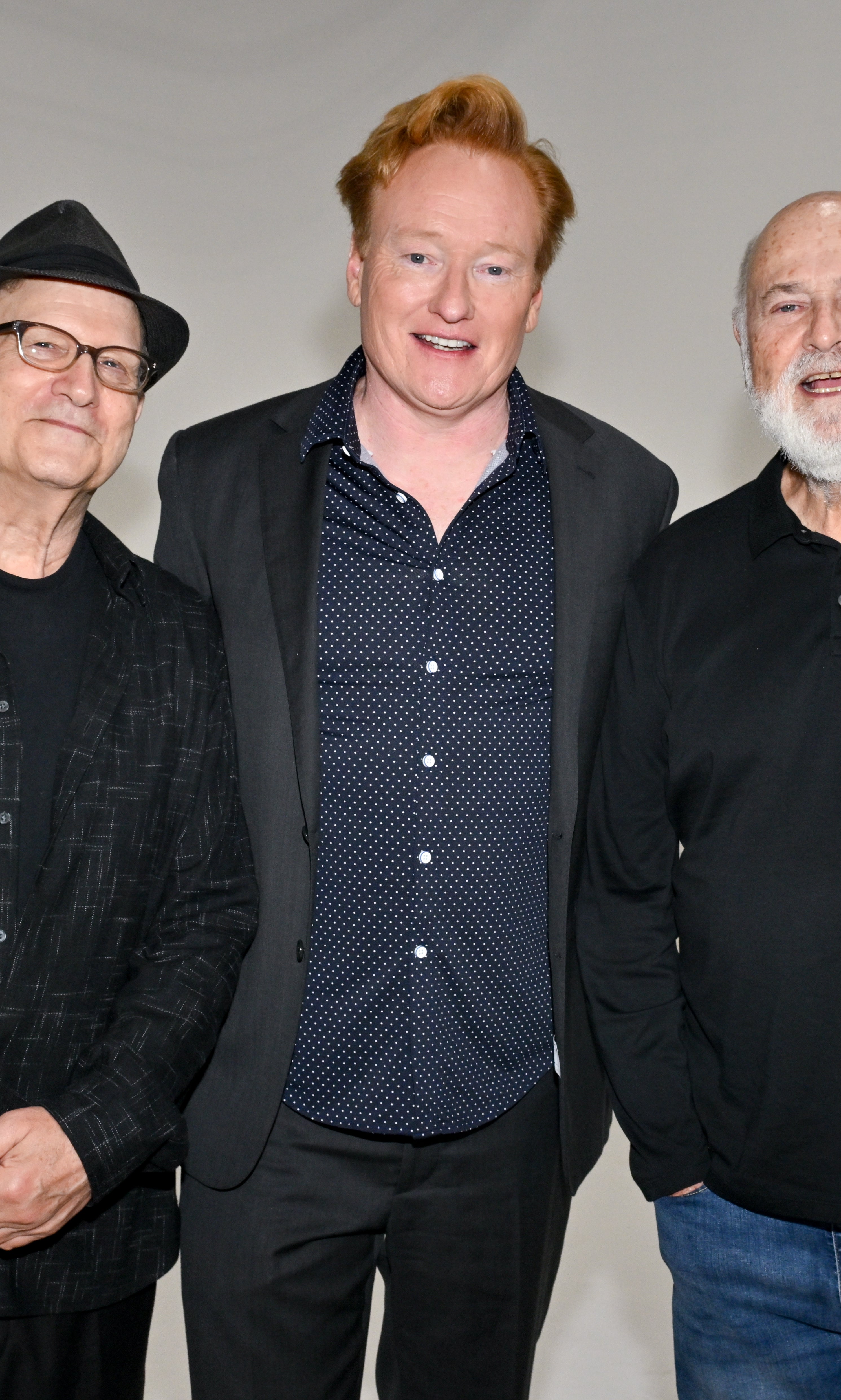 Three unidentified radical   basal   together, with the halfway  idiosyncratic   wearing a polka dot garment  and blazer, flanked by individuals successful  casual, acheronian  attire