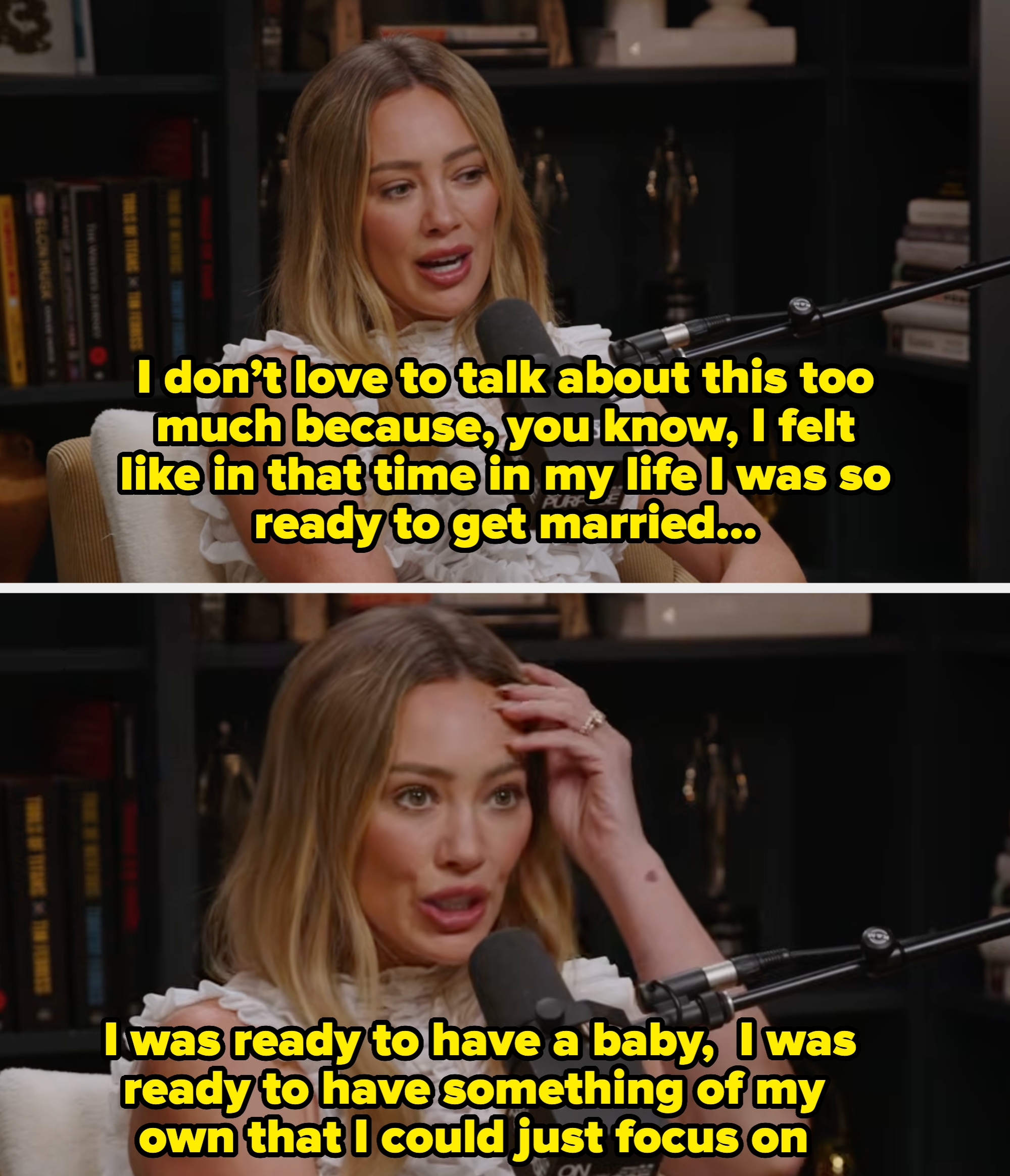 Person with long hair in a ruffled top speaks into a microphone during a podcast, seated in front of bookshelves