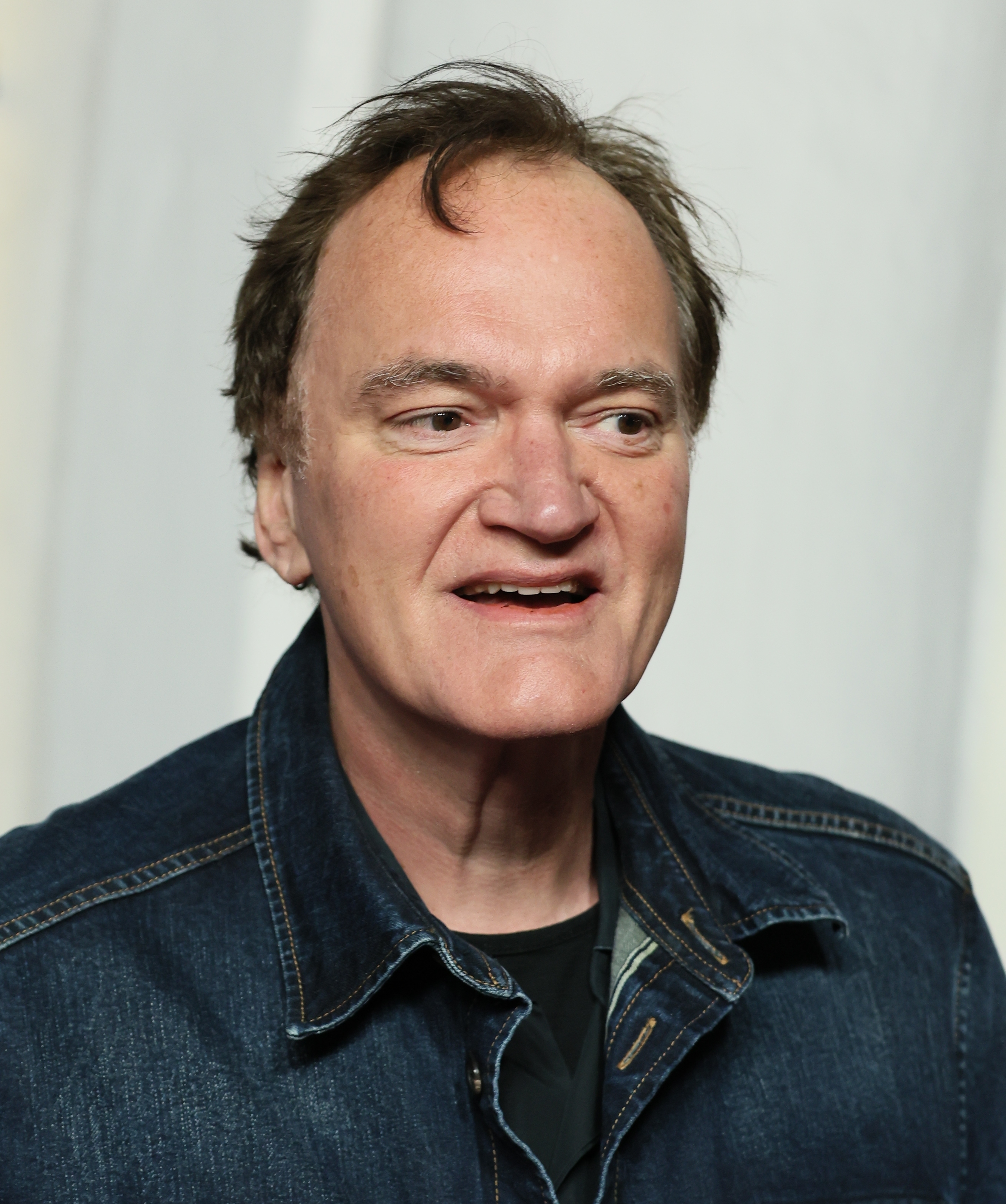 Person successful  a denim overgarment   smiling astatine  an event