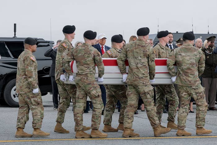 Soldiers transportation  a casket draped with a emblem  during a ceremonial  ceremony, with subject   unit   and officials successful  attendance