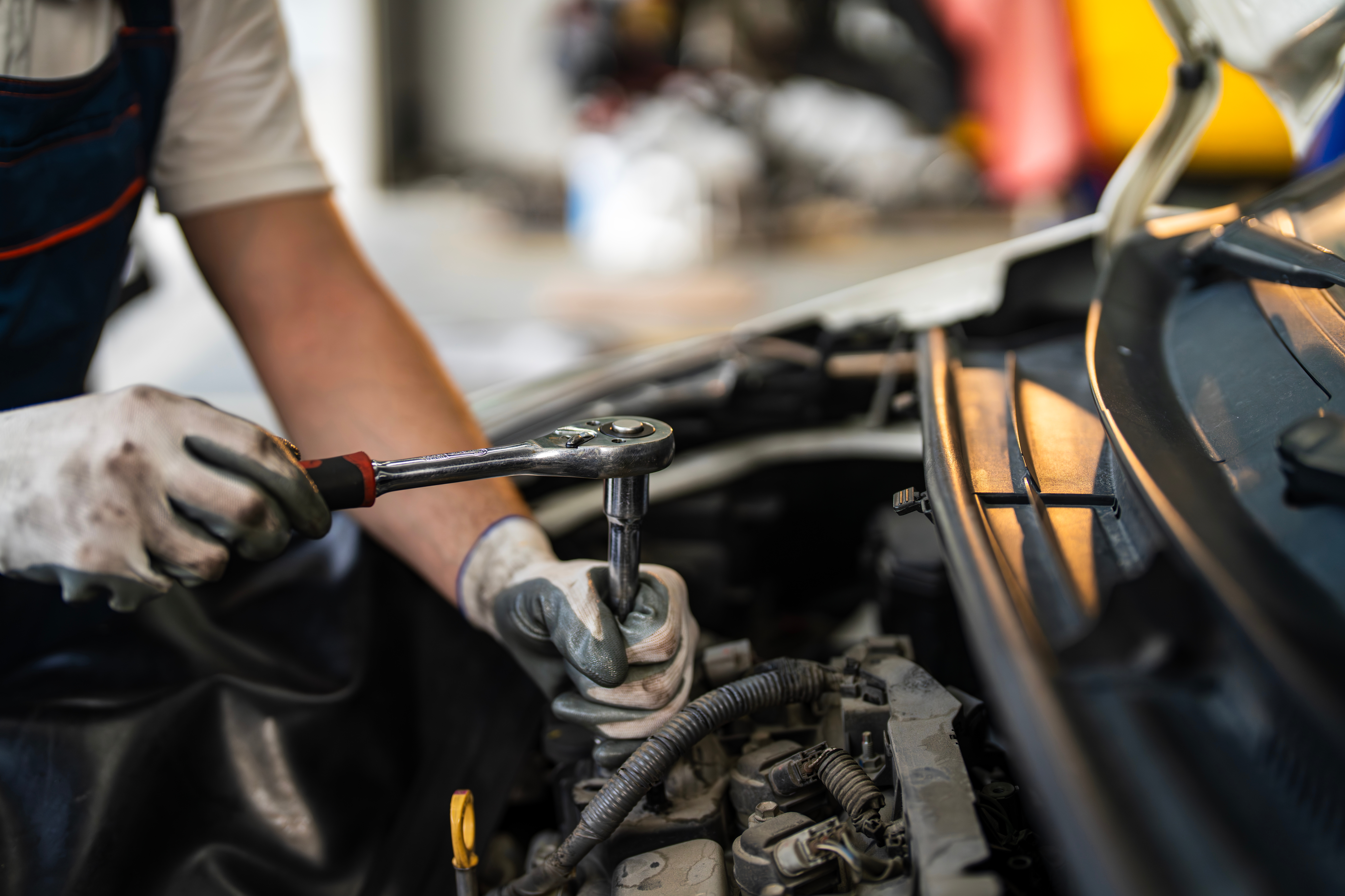 Mechanic utilizing a wrench to repair motor  successful  a garage
