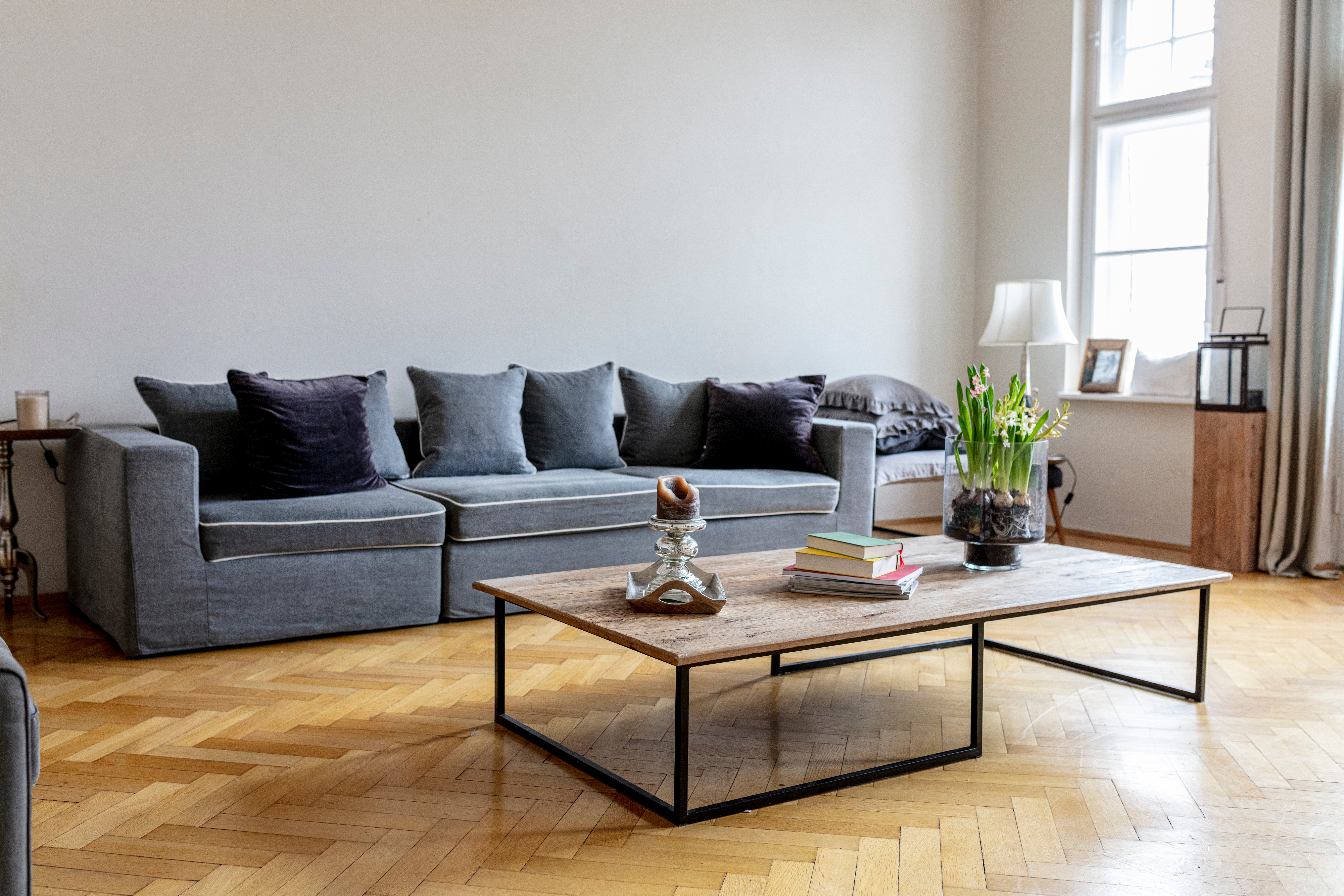 Minimalist surviving  country   with a ample  sofa, woody  java  array  holding books and decor