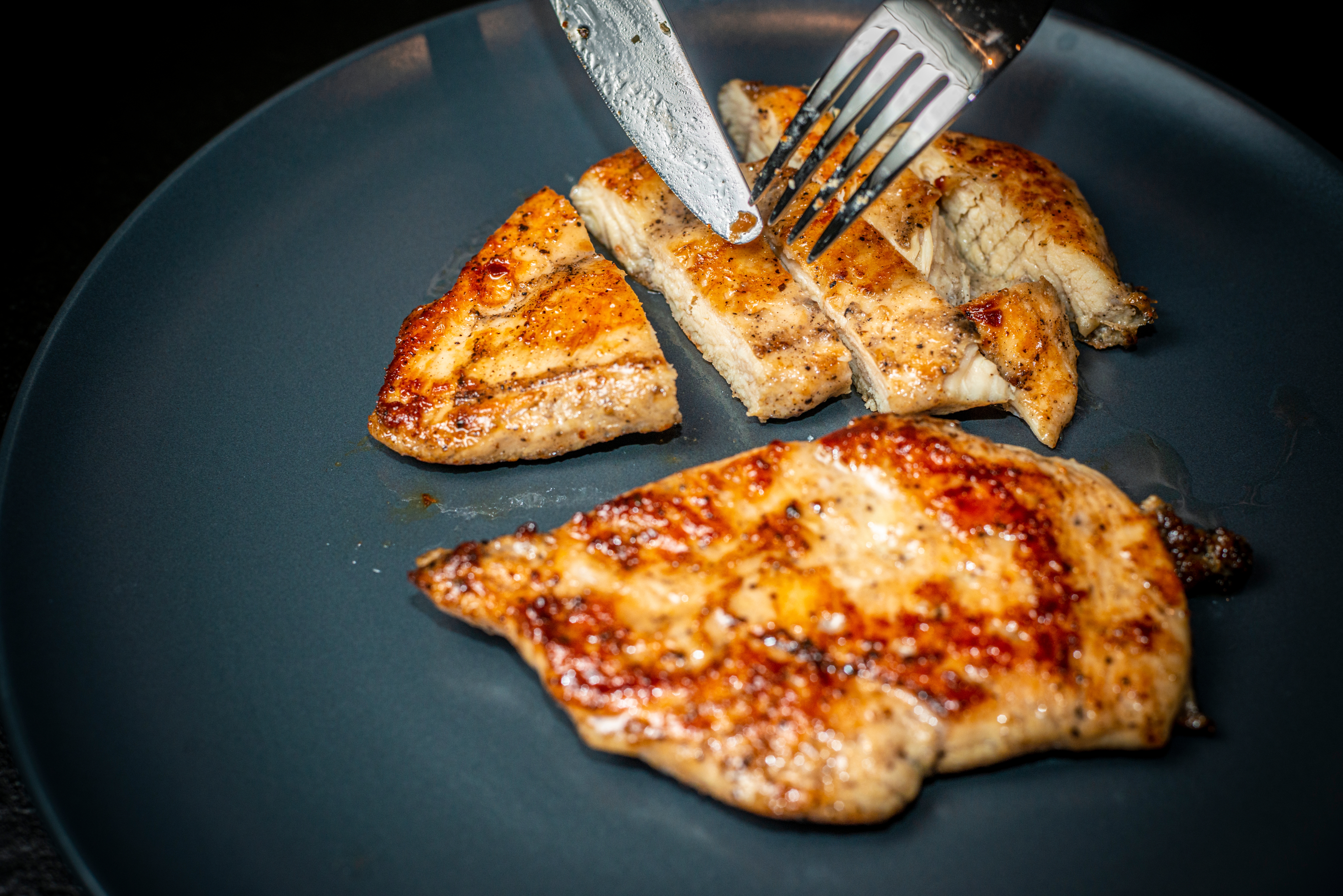 Grilled chickenhearted  bosom  being sliced connected  a acheronian  plate
