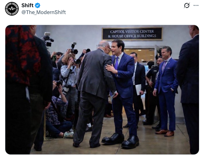 Marco Rubio speaking with Chuck Schumer; his shoes have been inflated so they are giant, like clown shoes