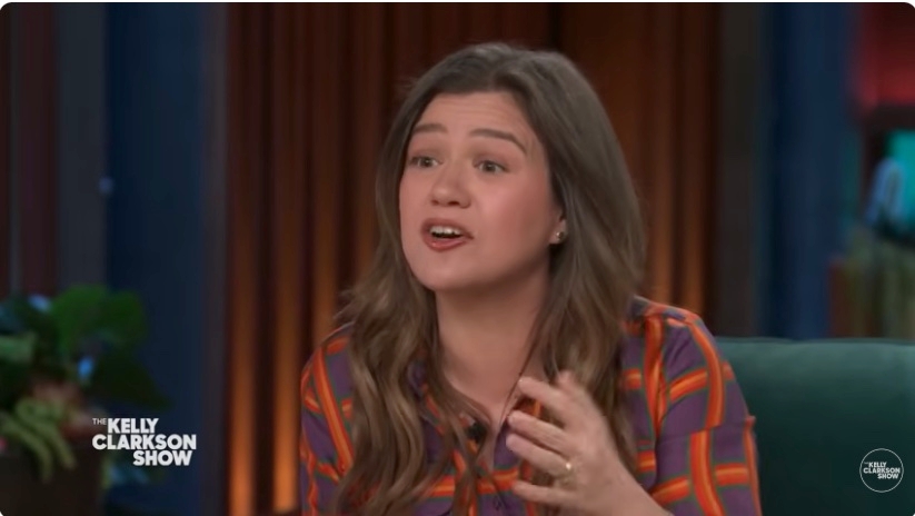 Kelly Clarkson talking animatedly on a talk show set with "The Kelly Clarkson Show" logo in the corner