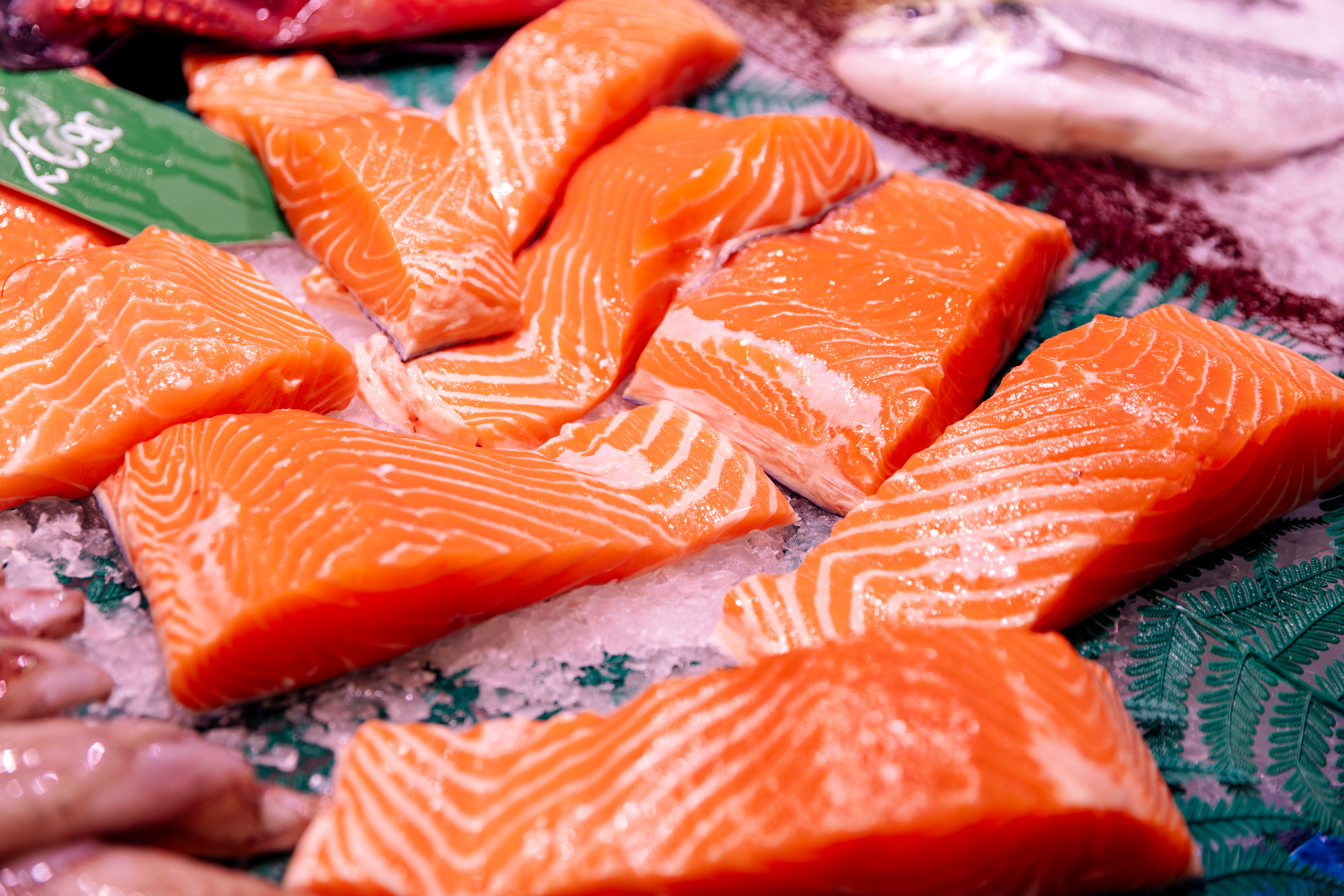 Salmon fillets arranged connected  crystal  astatine  a marketplace  display, showcasing the texture and freshness of the fish