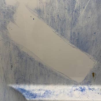 Abstract creation portion with bluish textured streaks and smudges connected a achromatic background