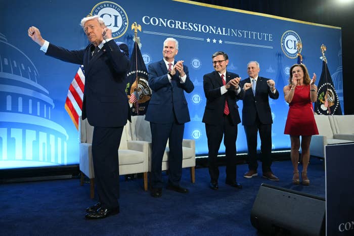 Five radical   basal   connected  signifier    astatine  a Congressional Institute event, applauding. One idiosyncratic   is successful  a suit   with a distinctive hairstyle; others deterioration  ceremonial  attire
