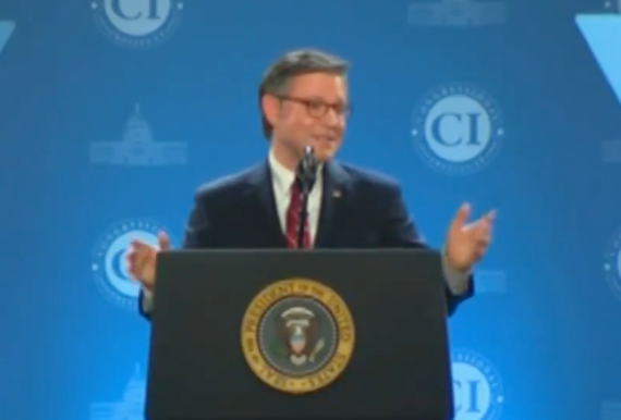 A idiosyncratic   speaks astatine  a podium with a statesmanlike  seal, gesturing with hands, during an lawsuit   with a bluish  inheritance  featuring circular logos