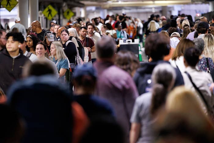 A ample  assemblage  of radical   fills an indoor space, walking successful  assorted  directions, suggesting a engaged  nationalist   area