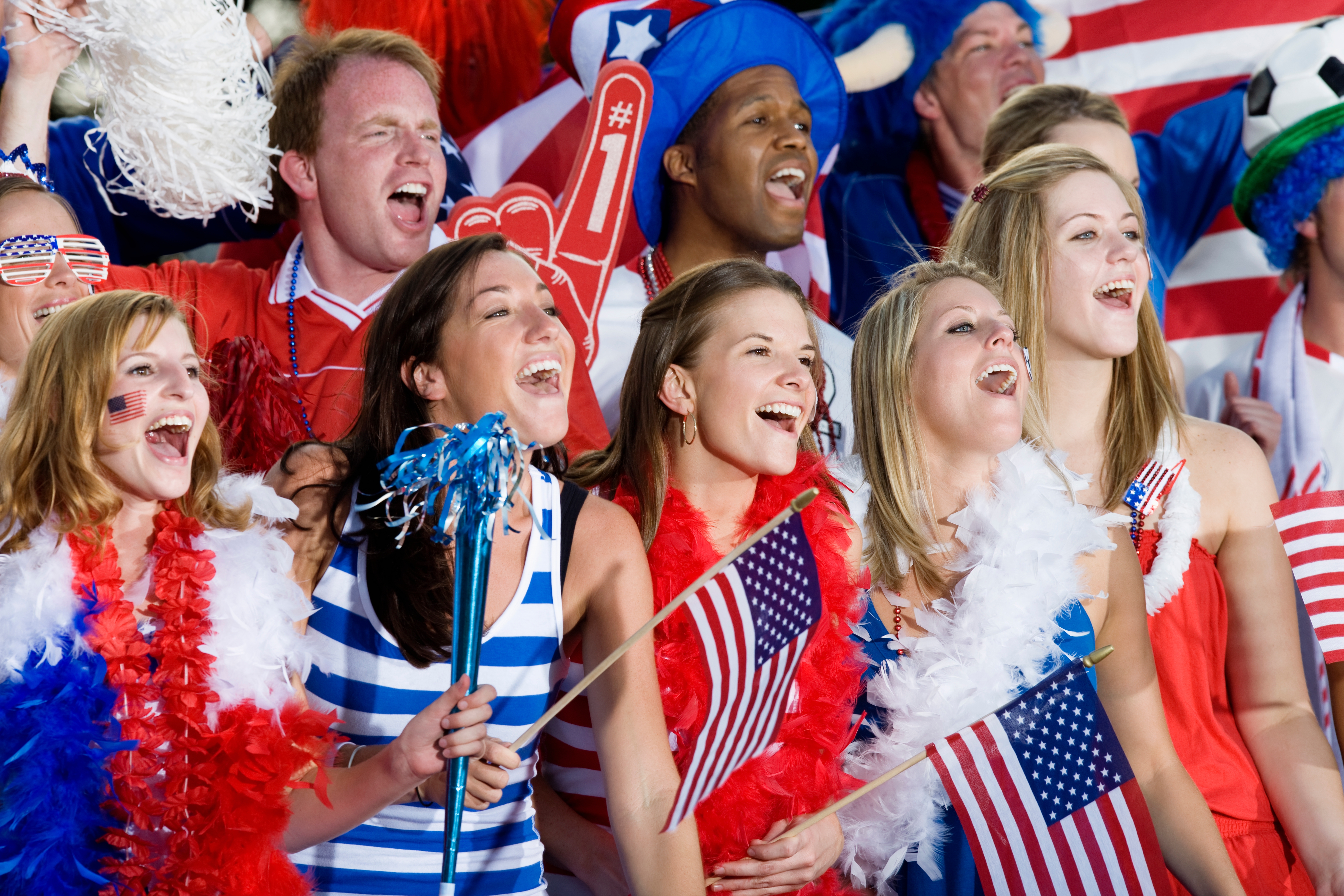 Group of radical   successful  patriotic attire, smiling and holding American flags and decorations, celebrating unneurotic  enthusiastically