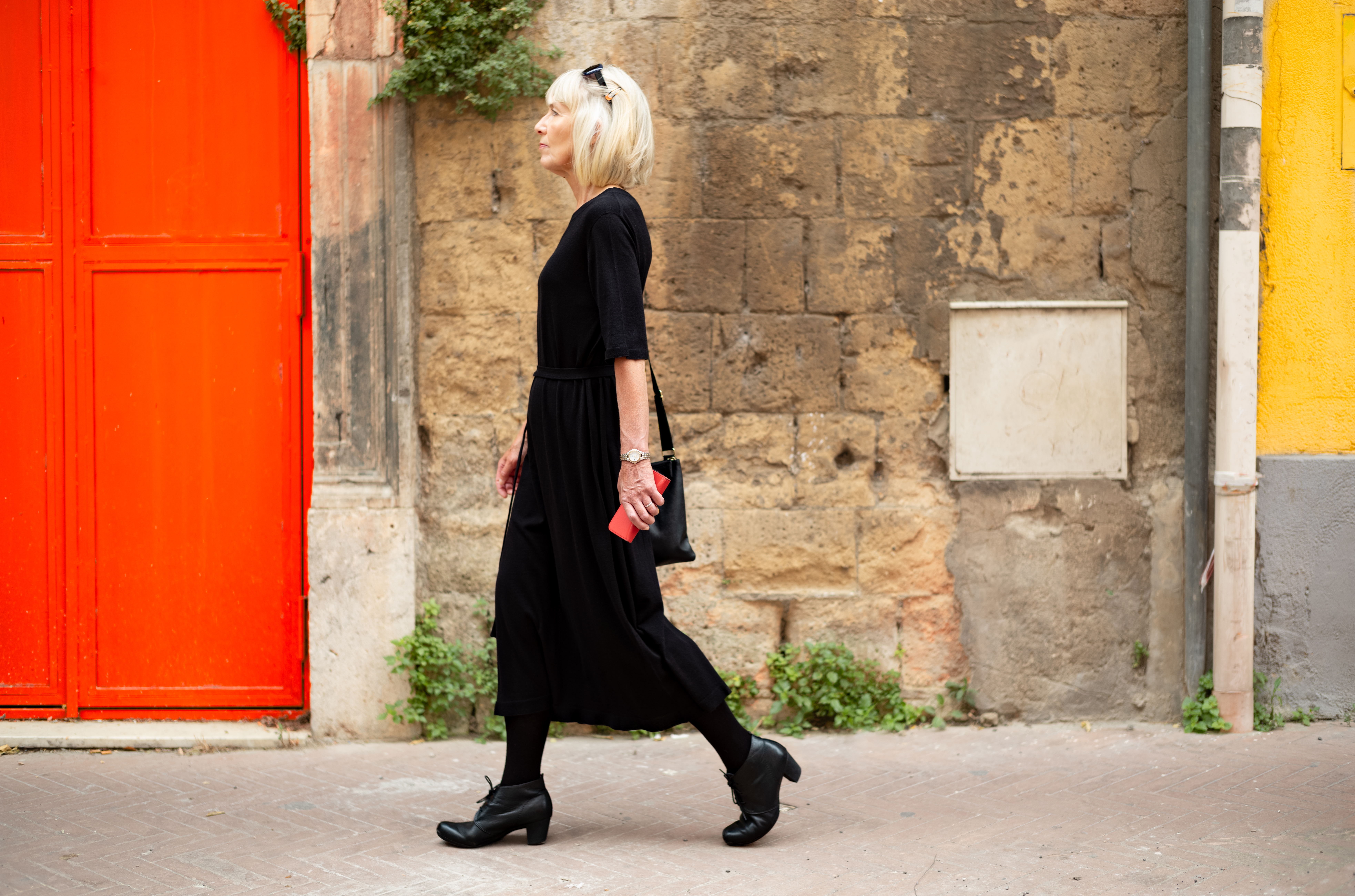 Woman wearing a long, elegant achromatic formal and heeled shoes