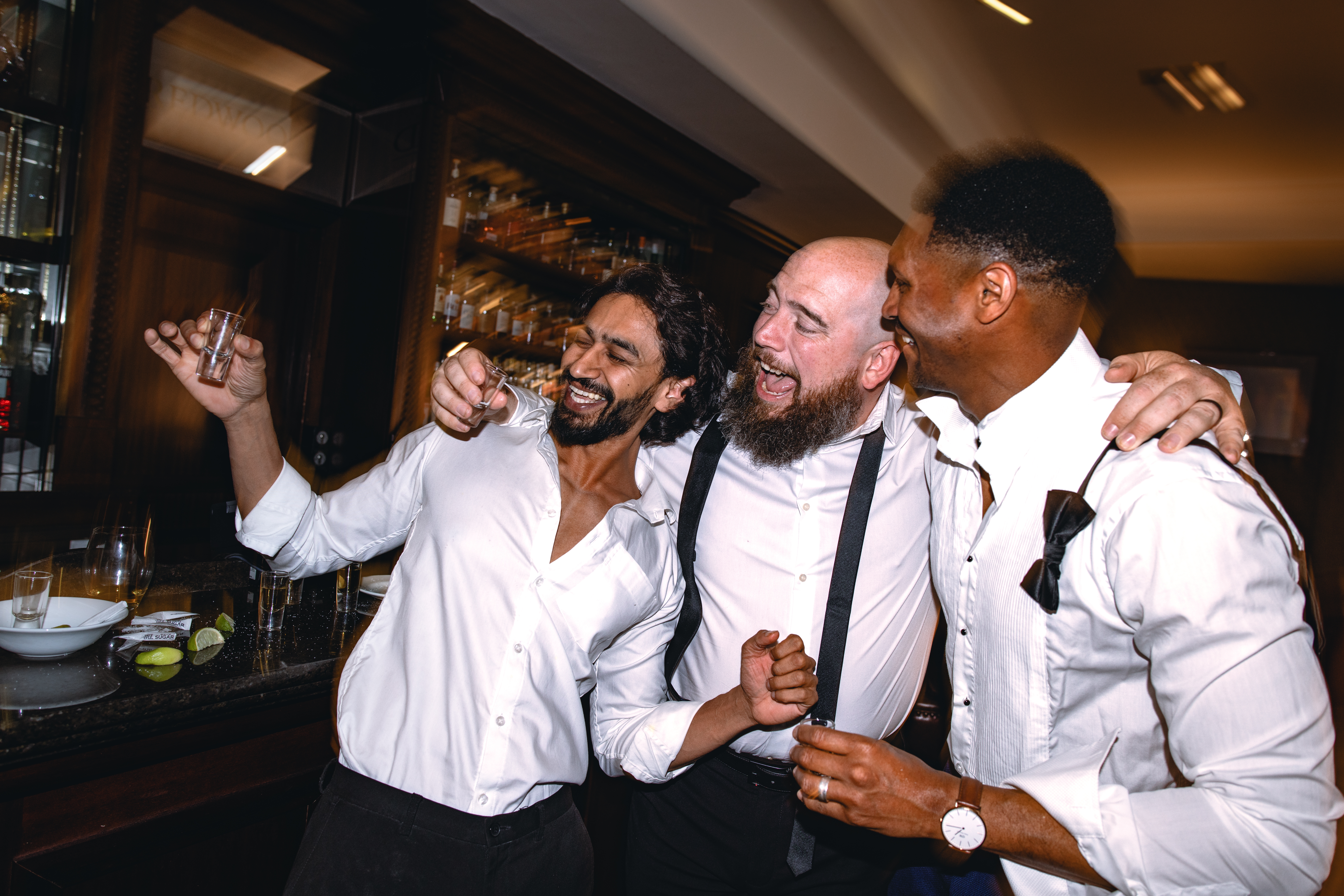 Three men successful formal shirts laughter and instrumentality shots together