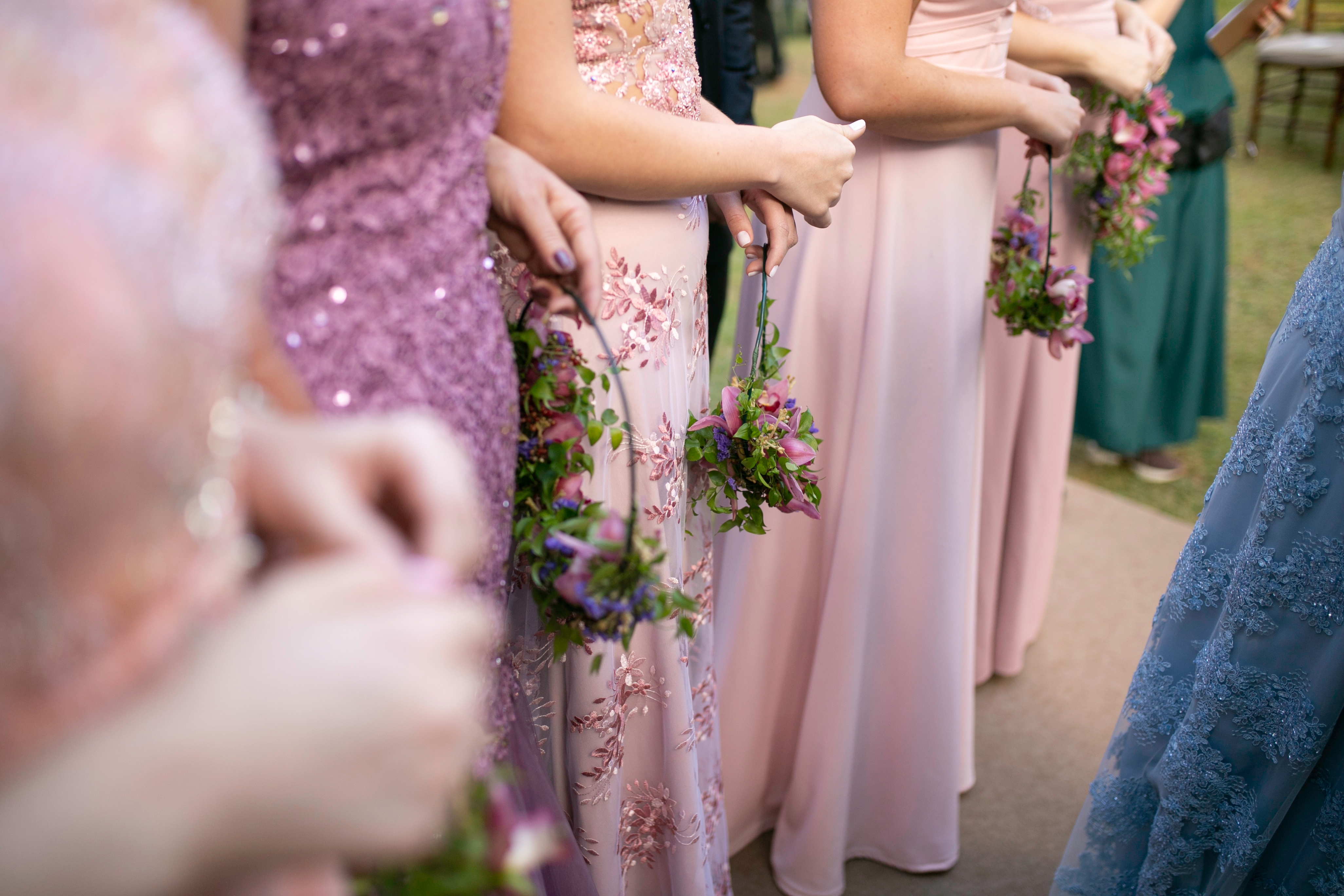 Bridesmaids holding floral bouquets basal successful enactment astatine a wedding ceremony