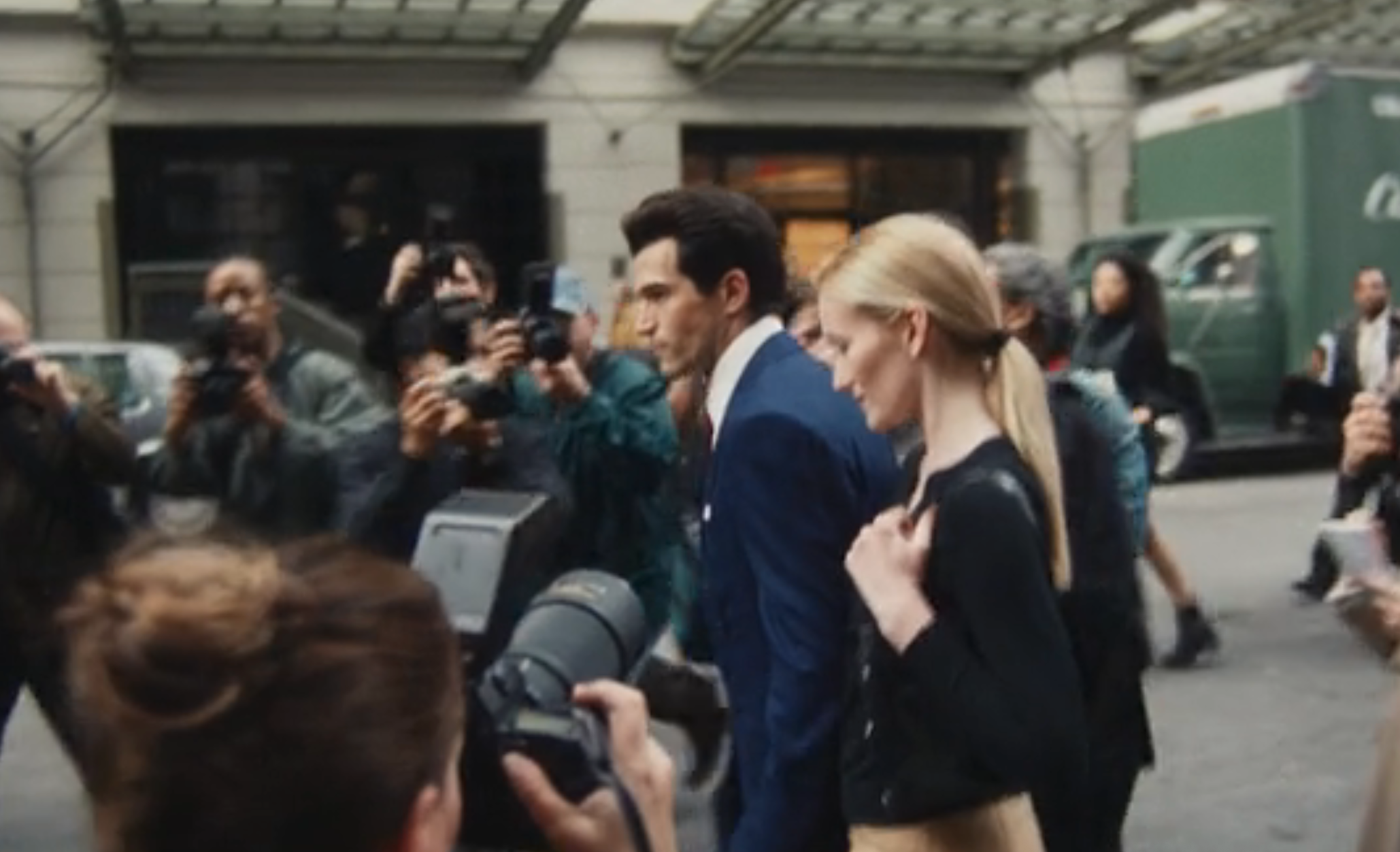 A well-dressed mates  walks done  a assemblage  of photographers connected  a street, suggesting a personage  oregon  high-profile lawsuit   arrival