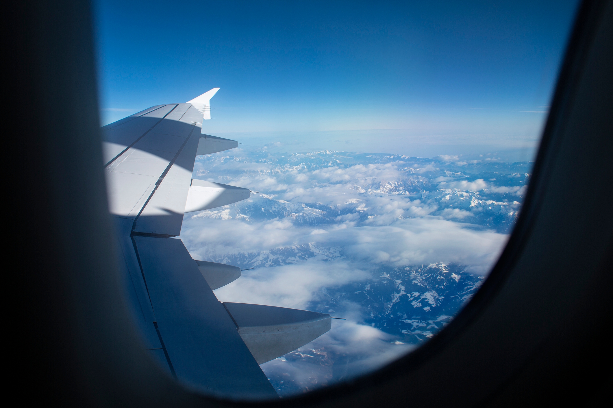 View from an airplane model   showing the helping  against a backdrop of clouds and mountains below