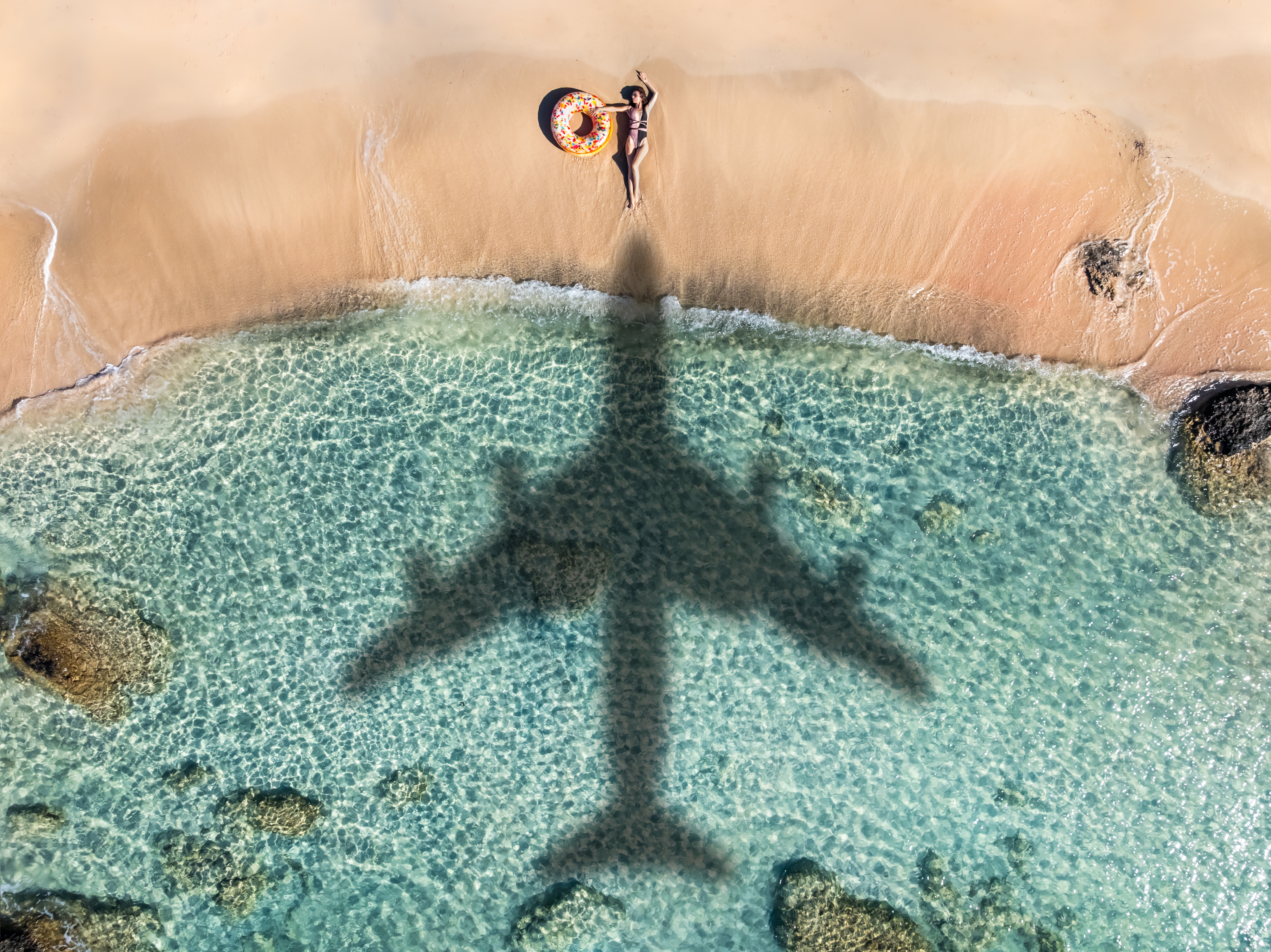 Person lounging connected  a formation  with an airplane shadiness   formed  implicit    the soil  and water, creating a melodramatic  ocular  contrast