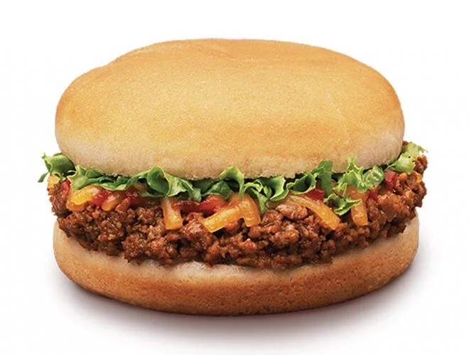 Sloppy Joe sandwich with seasoned crushed  meat, lettuce, and condiment  connected  a bun
