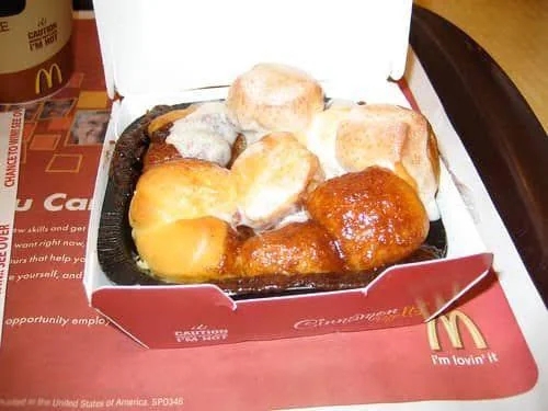 A container  of McDonald's cinnamon melts, featuring lukewarm  cinnamon rolls topped with icing