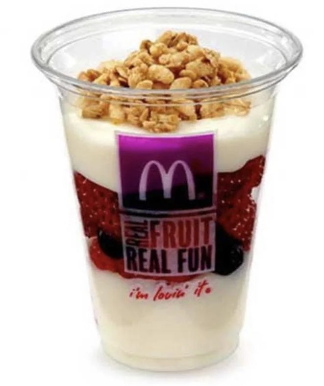McDonald's yogurt parfait successful  a wide   cupful  with layers of yogurt, mixed berries, and granola connected  top, featuring the McDonald's logo