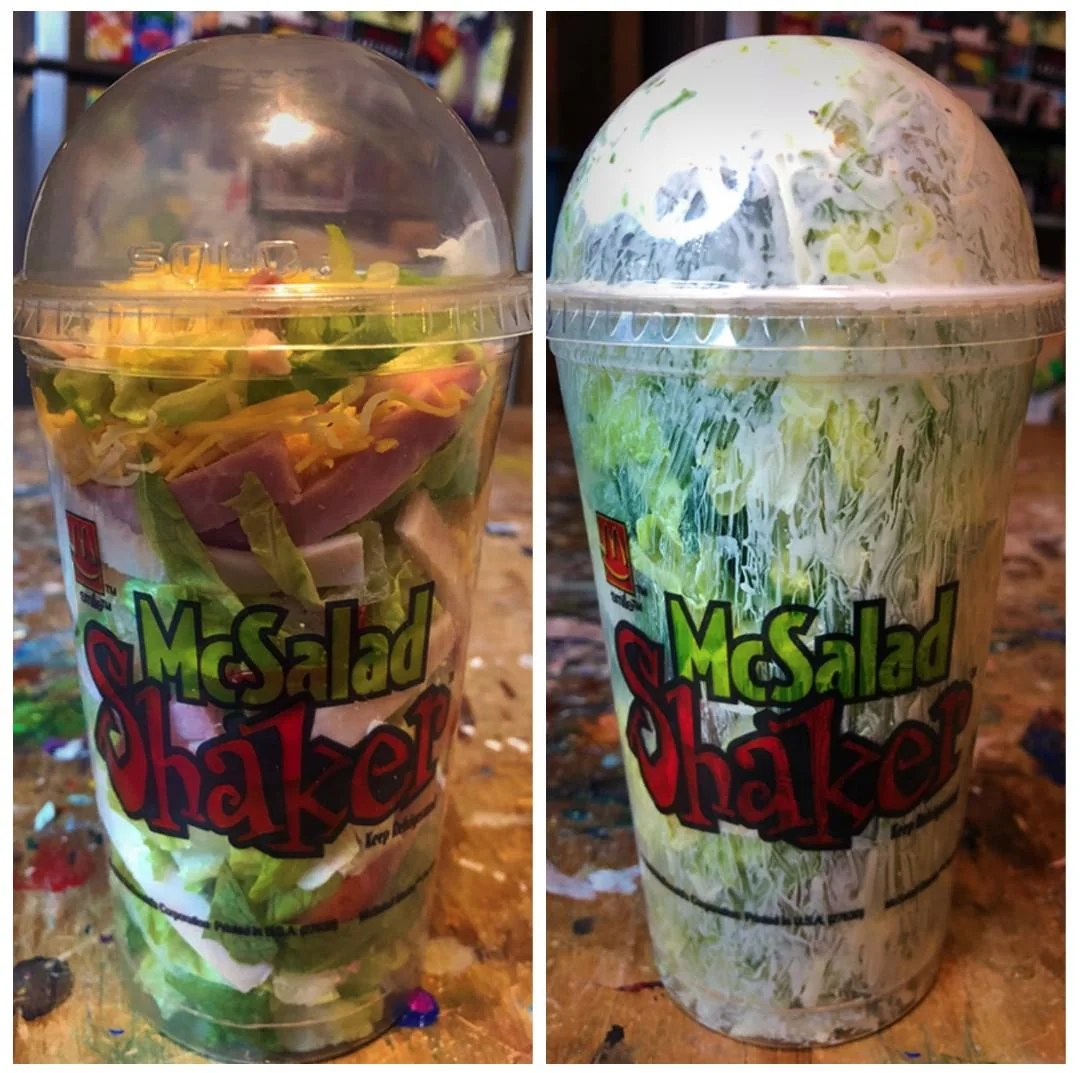 Two McSalad Shakers successful  wide   cups, 1  with ingredients disposable   and the different   shaken, showing mixed crockery   inside