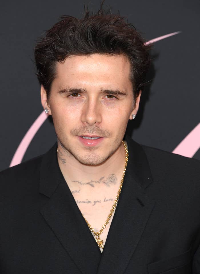 Brooklyn with abbreviated  hairsbreadth  and a achromatic  suit   overgarment   connected  a reddish  carpet event