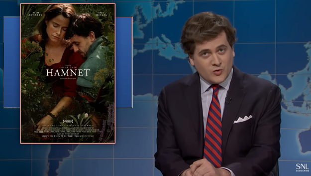 A idiosyncratic   successful  a suit   speaks connected  a news-style set. Beside them, a poster for "Hamnet" is displayed, featuring 2  individuals successful  an affectional  pose