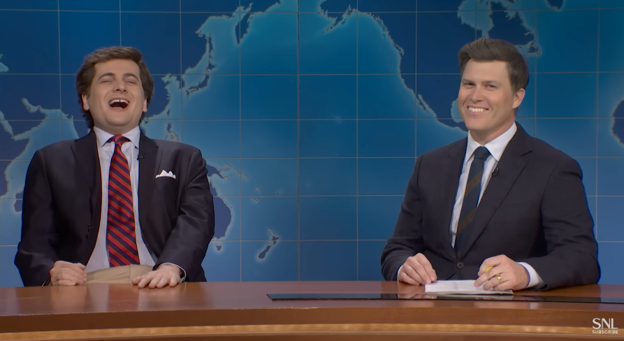 Two radical   beryllium   astatine  a quality    desk, 1  is laughing portion    the different   smiles. A satellite   representation  is successful  the background