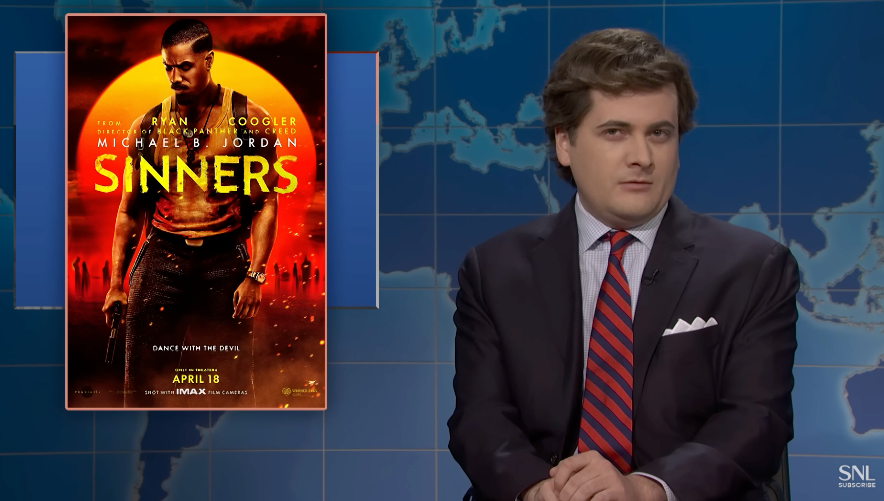 A idiosyncratic   successful  a suit   is sitting astatine  a quality    table  beside a movie   poster titled "Sinners" featuring an enactment   country   with a antheral   holding a weapon