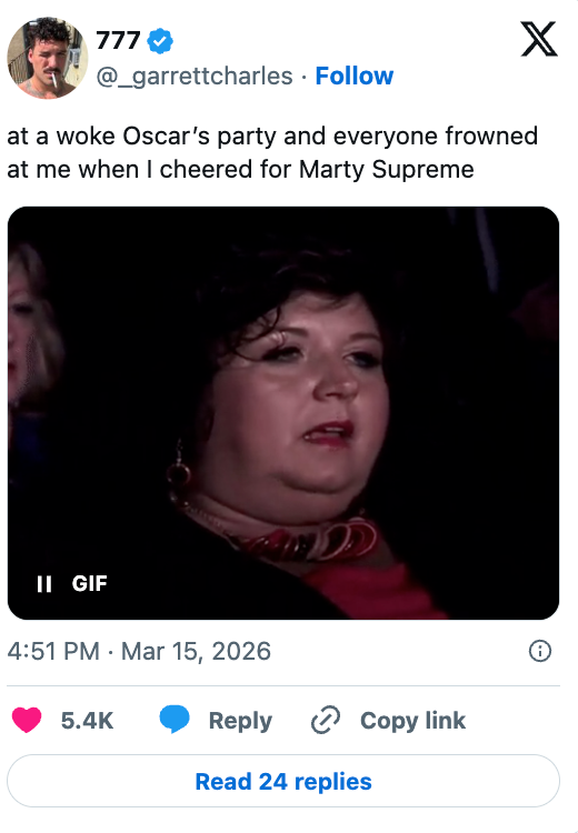 GIF of a person in a crowd shown from shoulders up, appearing to wear formal attire, with a tweet joking about cheering at an event