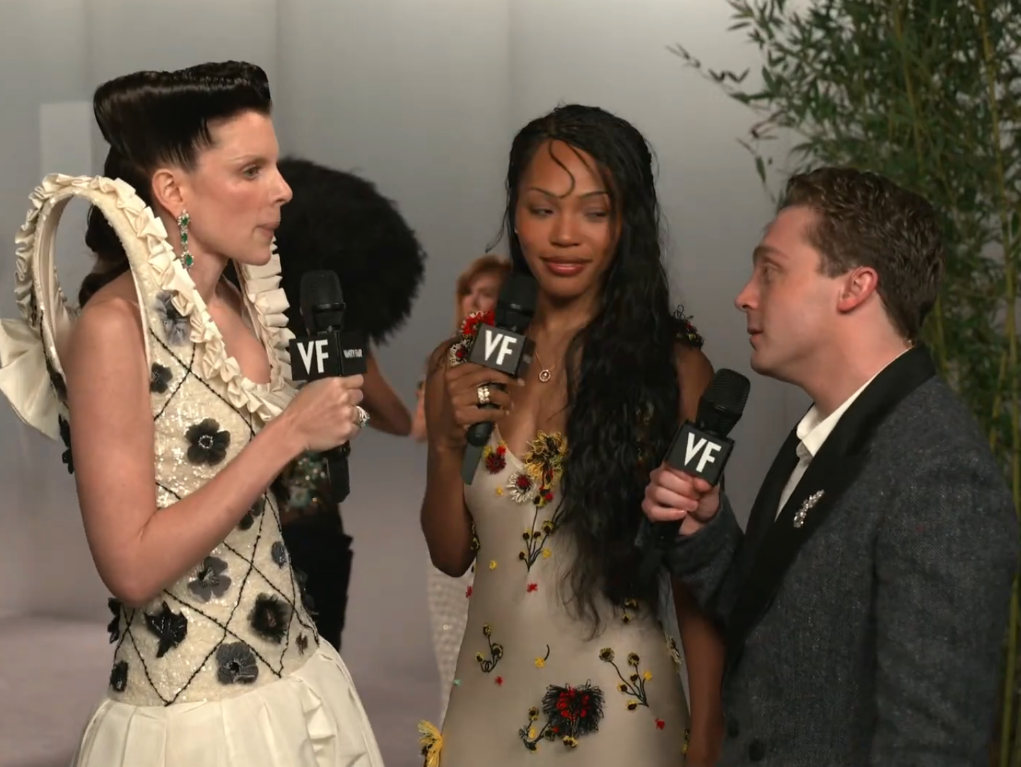 Three individuals being interviewed connected the reddish carpet, dressed successful elegant, stylish clothing