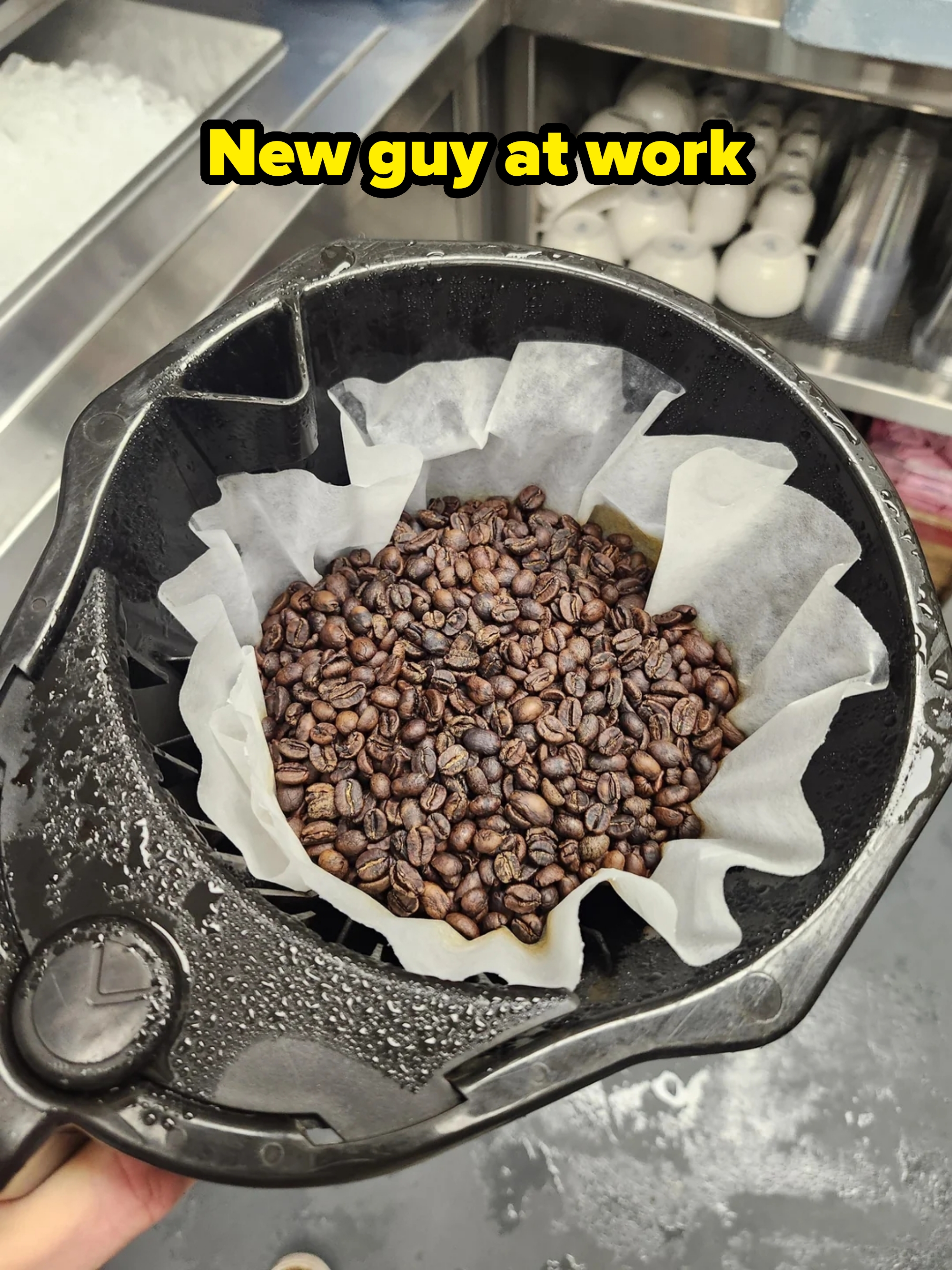 Coffee beans successful  a paper-lined java  instrumentality   filter positioned supra  a descend  successful  a room  setting