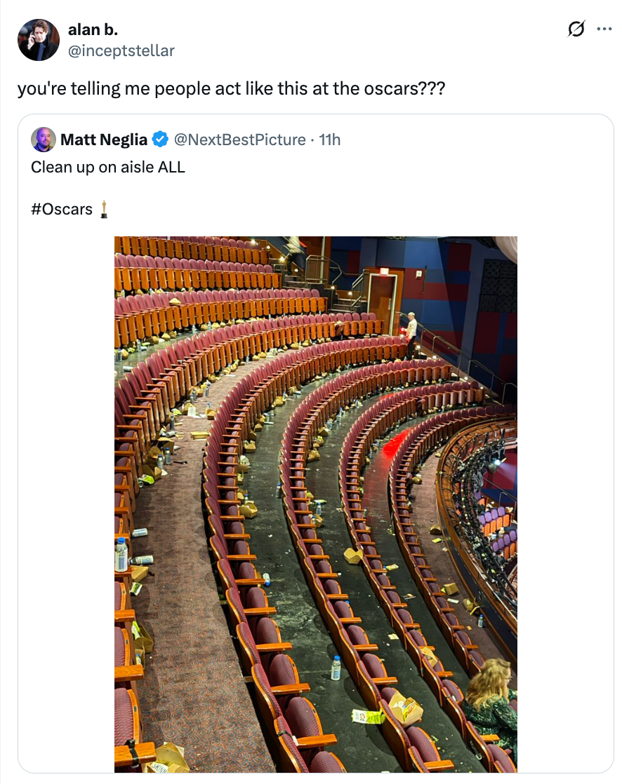 A messy theatre aisle filled with trash aft an event, highlighting improper cleanup behavior