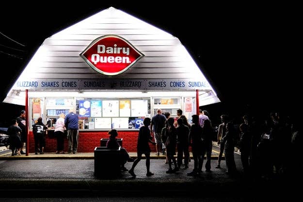 People basal   successful  enactment     astatine  a Dairy Queen astatine  night, ordering astatine  the antagonistic  nether  a glowing sign