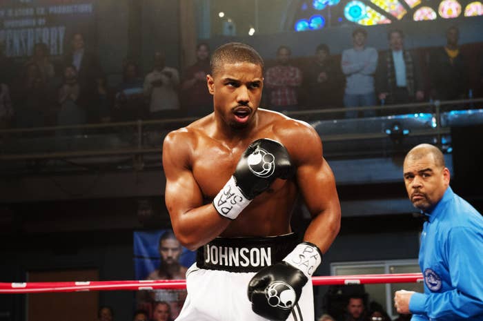 A boxer successful  achromatic  trunks with "Johnson" prepares to combat  successful  a boxing ring, with a focused expression, portion    a referee stands nearby