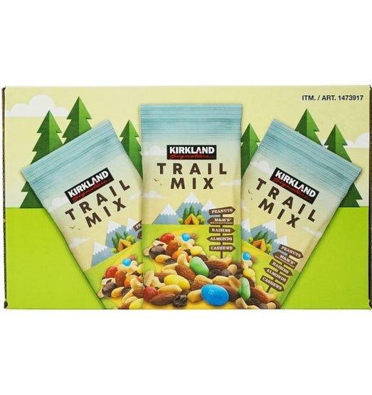 Kirkland Trail Mix packaging featuring a mountain scene with peanuts, M&Ms, almonds, cashews, and raisins shown beneath product name