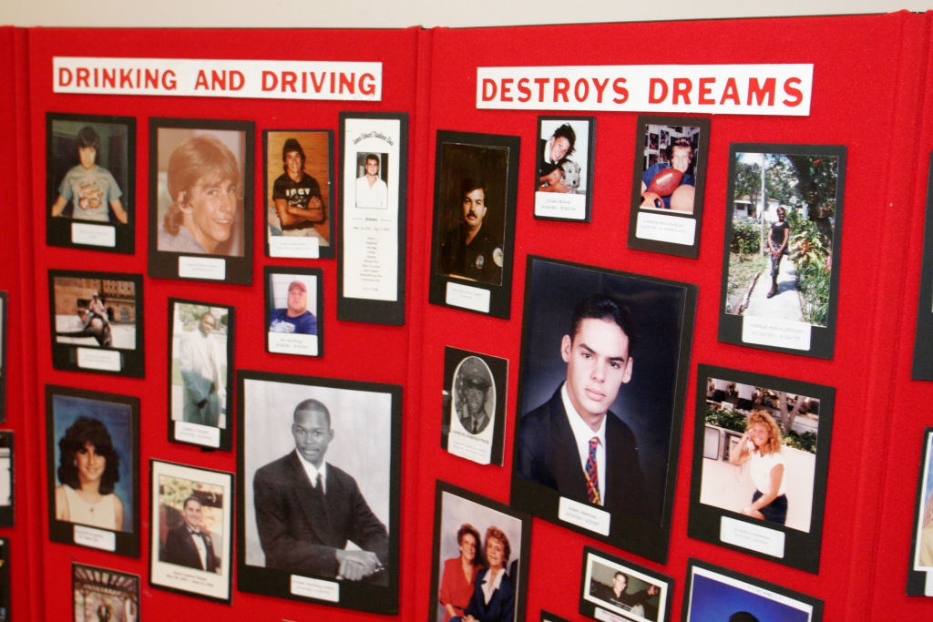Display committee  showing photos of individuals affected by drinking and driving; titled "Drinking and Driving Destroys Dreams."