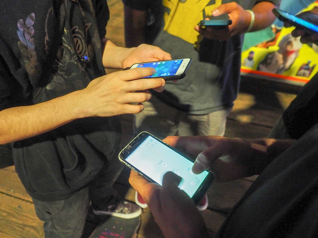 People utilizing smartphones, apt  playing a mobile crippled  together