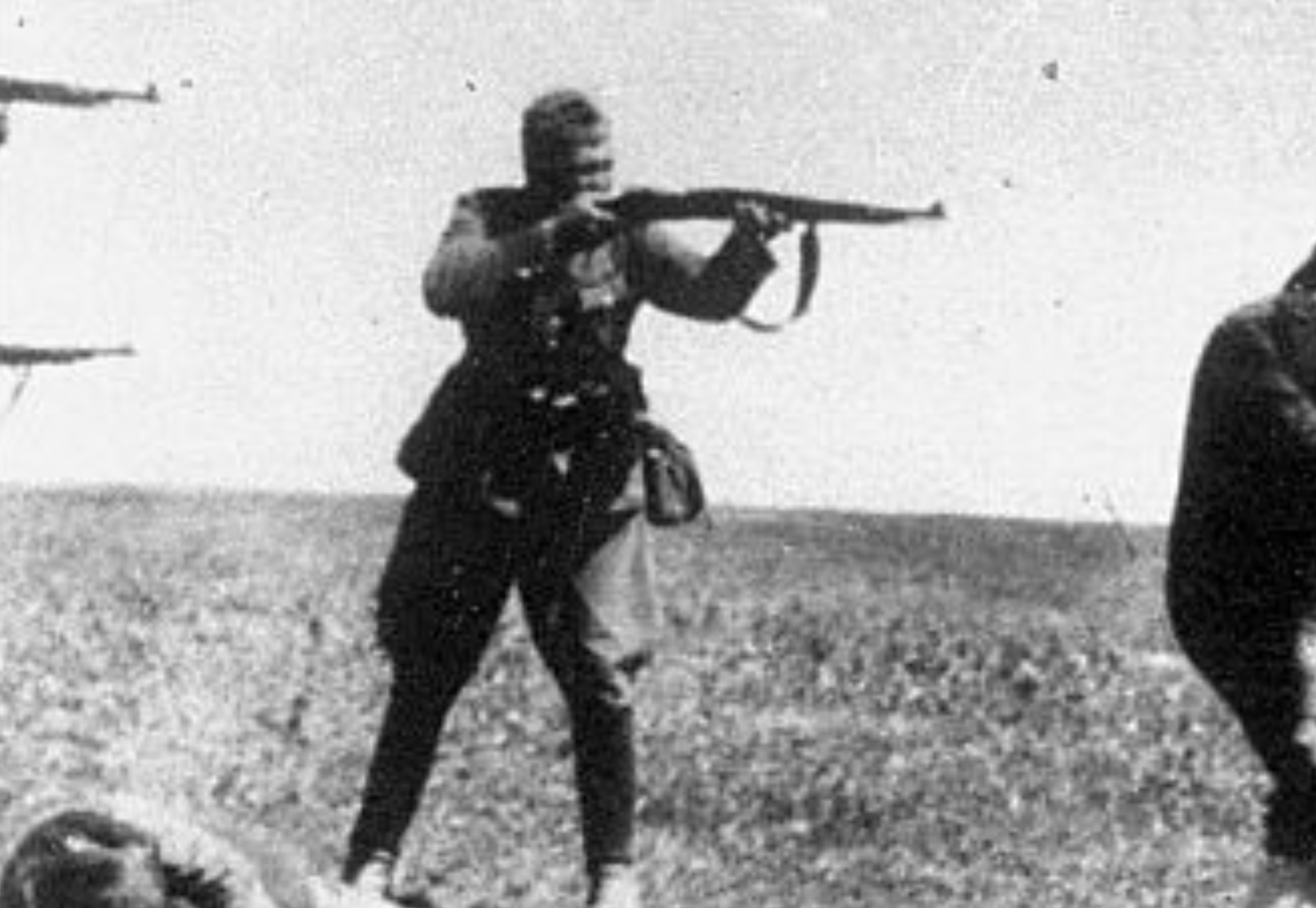 Historical photograph  of soldiers executing civilians successful  a barren field, capturing a infinitesimal   of aggravated  calamity  and conflict