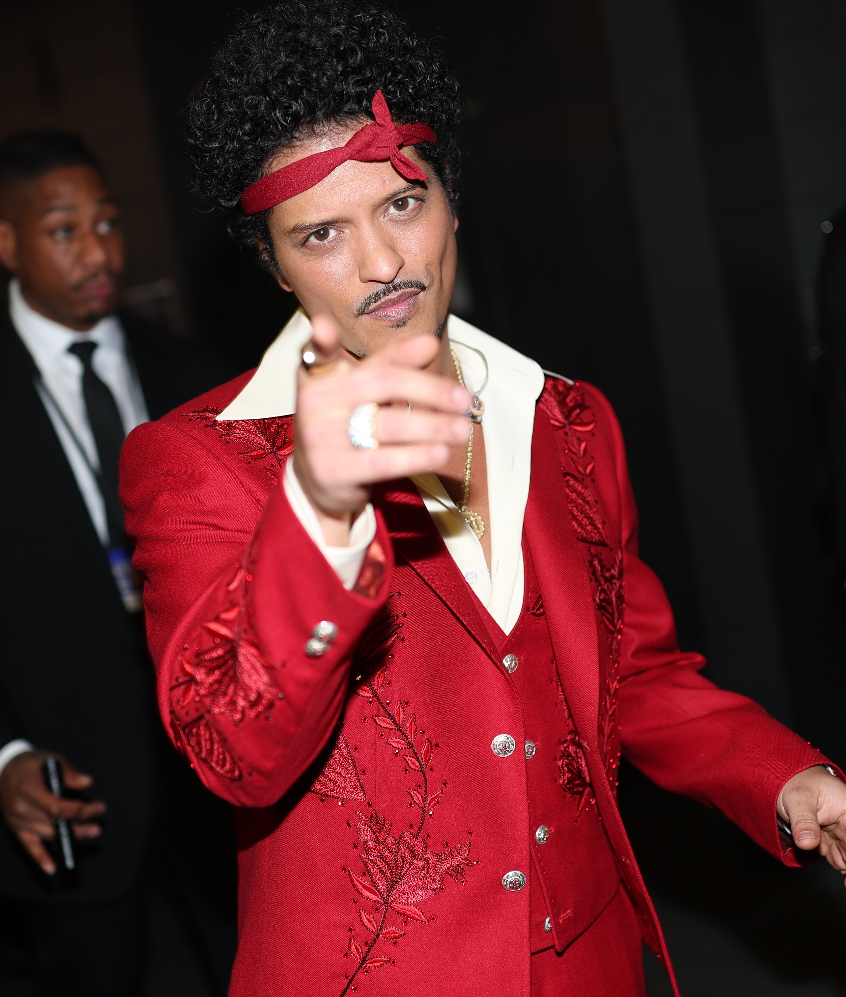 Bruno pointing astatine  the camera, lasting  successful  a assemblage  astatine  an event