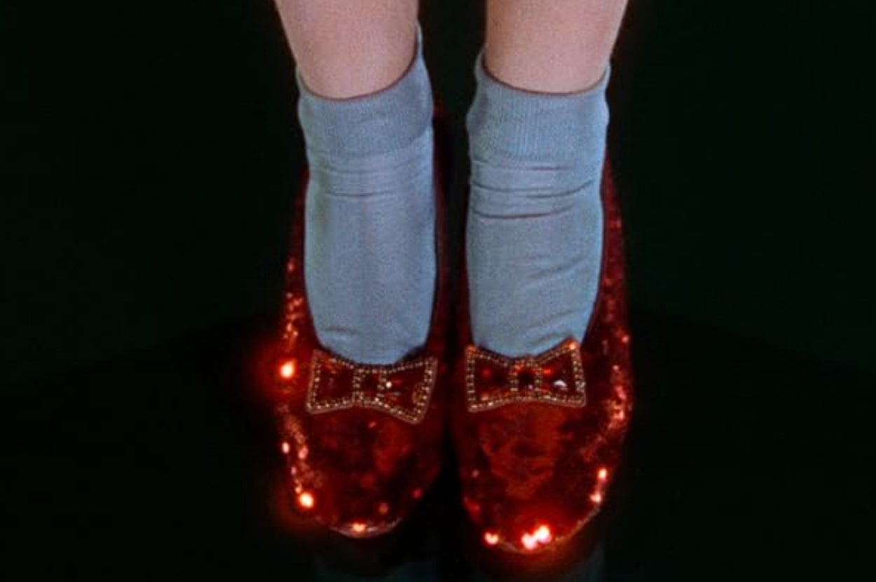Close-up of sparkling shoes with bows, worn with light socks