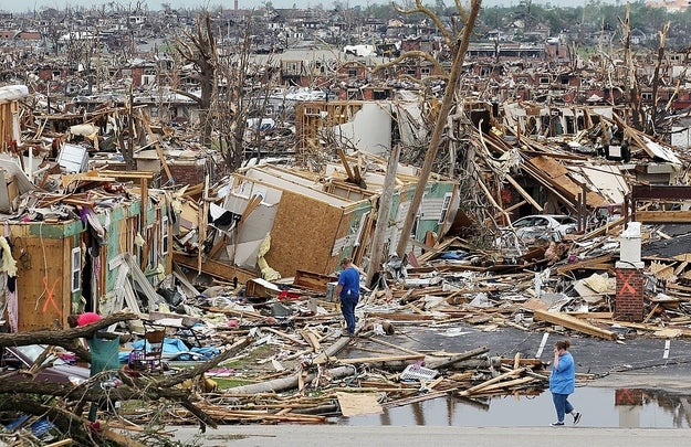 People locomotion done debris and demolition successful a residential country aft a tornado