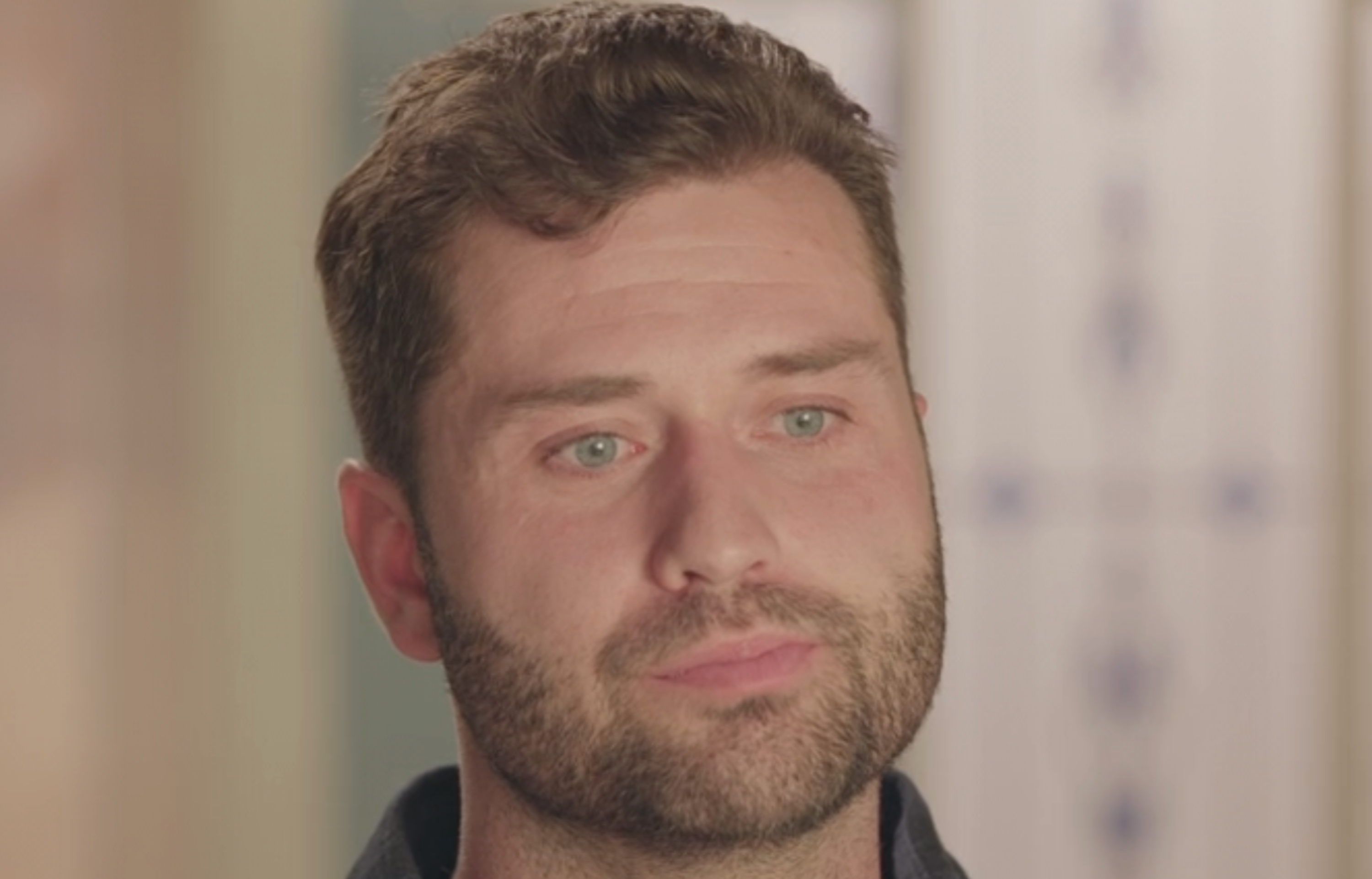 Person named Dakota, 32, with statement   "Taylor's Baby Daddy," sitting and looking thoughtful successful  an indoor setting