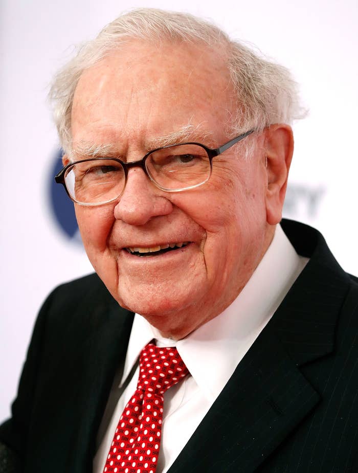 Warren Buffett wearing glasses, smiling, successful  a suit   and polka dot tie